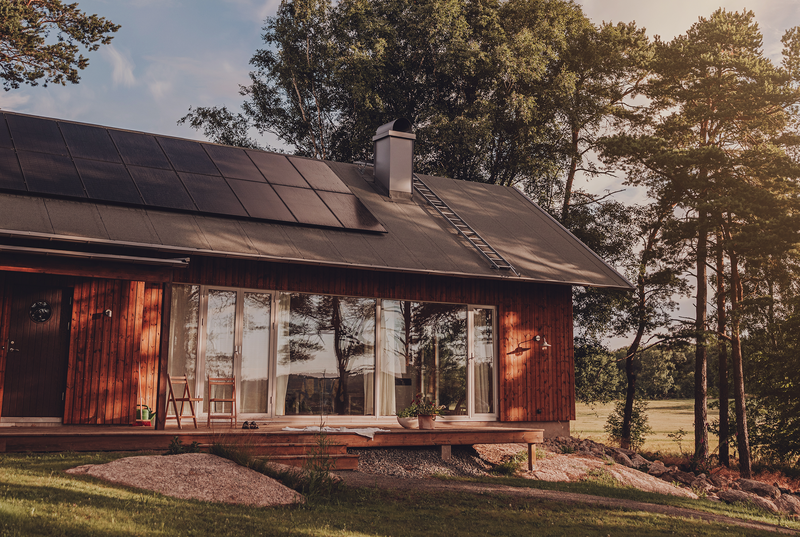 Holzhaus mit PV-Anlagen in der Natur (Lohnt sich Photovoltaik? Fazit)
